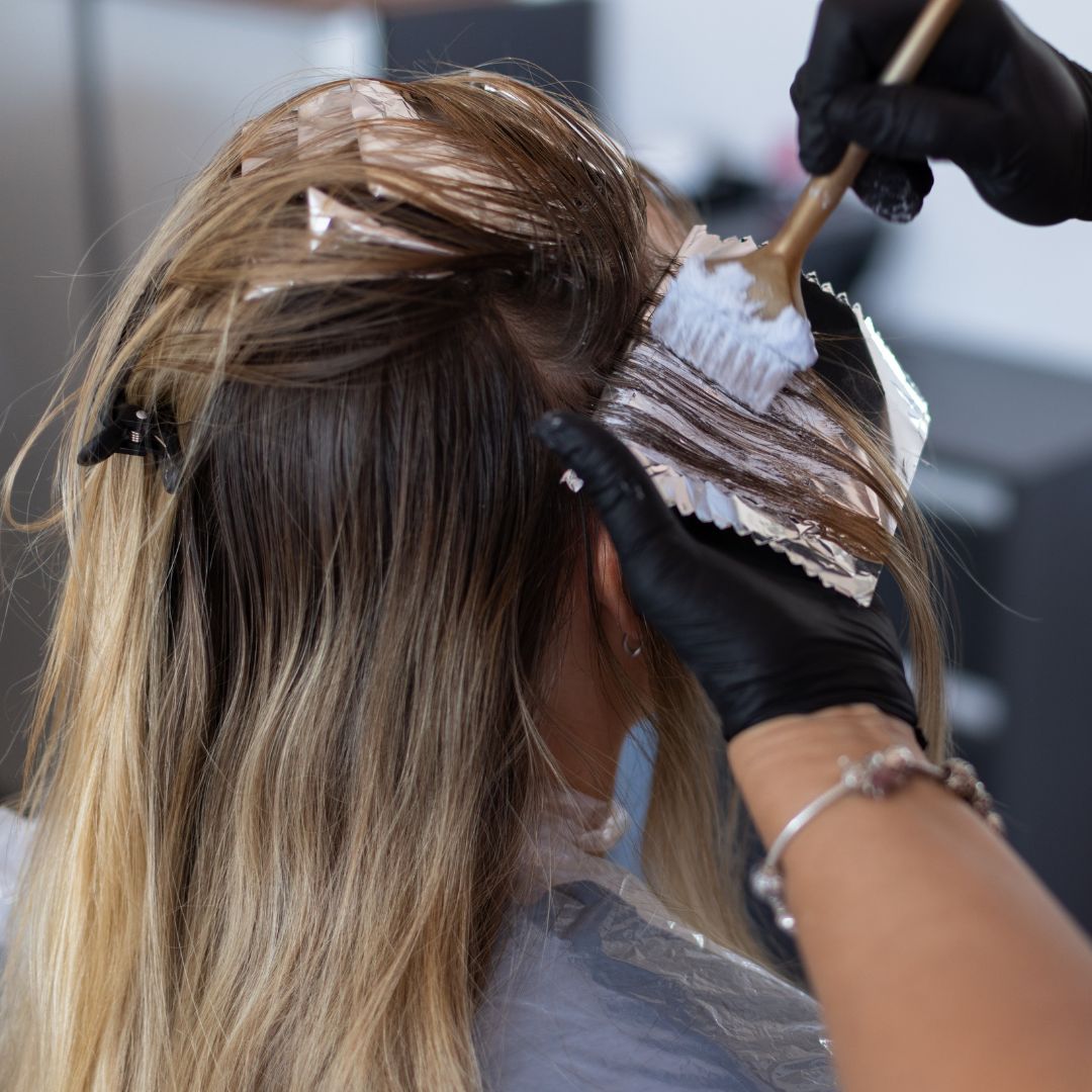Stylist applying hair color